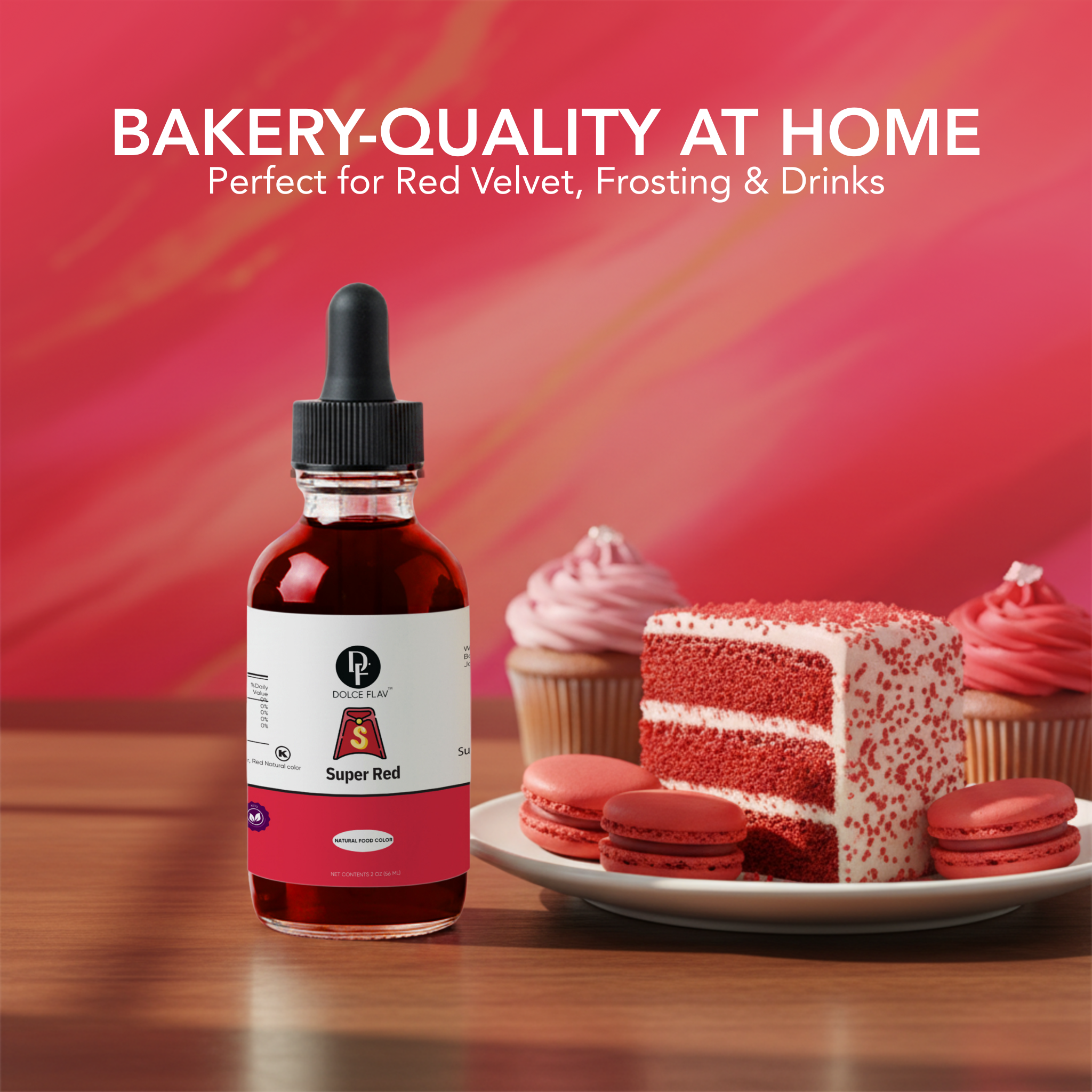Bottle of red food coloring with a cake and cupcakes on a wooden surface against a red background.